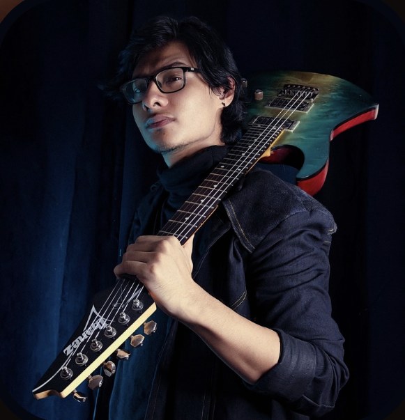 Jay Rana holding his guitar