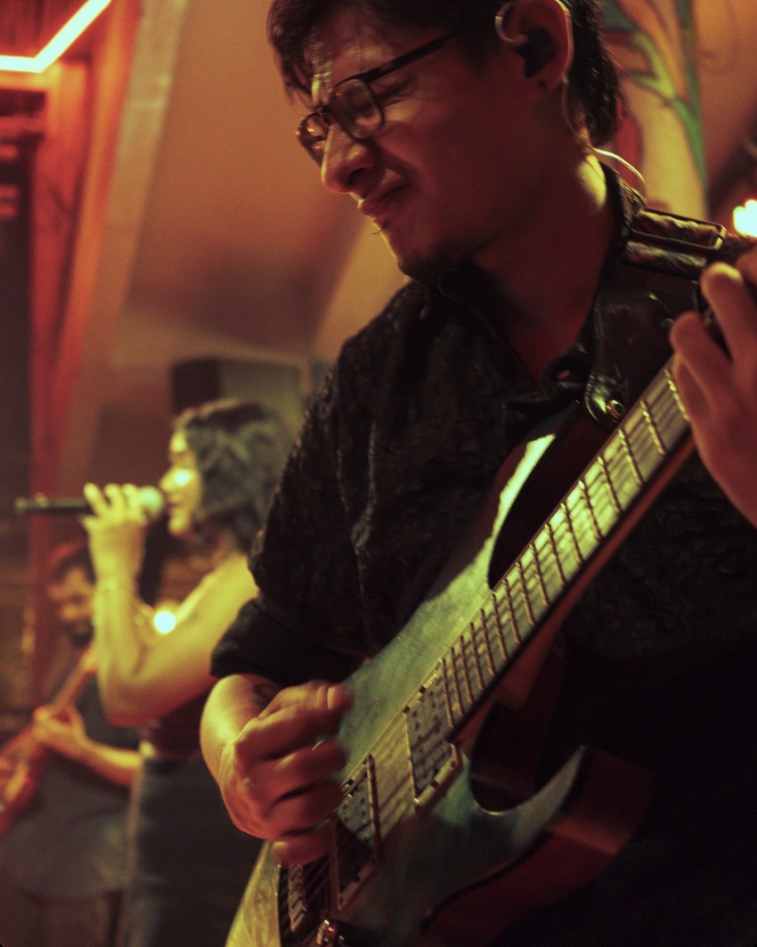 Jay Rana playing guitar on stage