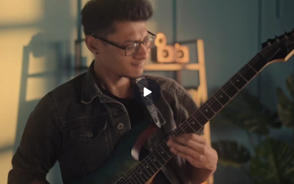 Jay Rana playing guitar in a video still